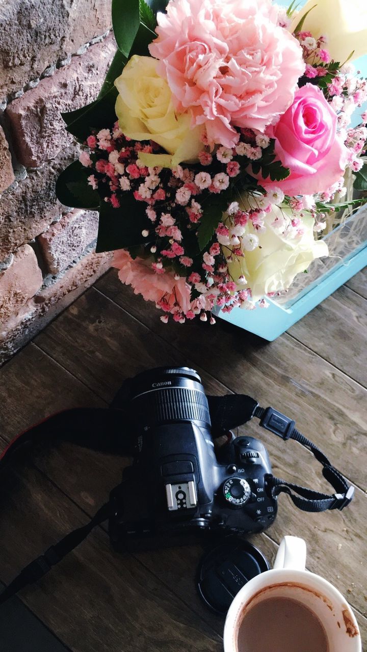 flower, table, high angle view, bouquet, camera - photographic equipment, vase, wood - material, beauty in nature, petal, indoors, nature, no people, freshness, flower head, day, fragility, photography themes, close-up