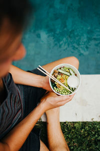 Midsection of woman holding bowl