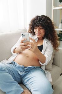 High angle view of woman lying on bed at home