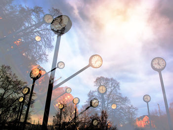 Low angle view of illuminated street light against sky