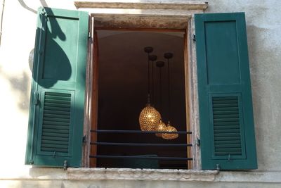 Illuminated light bulbs hanging on window of door