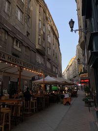 People on street amidst buildings in city