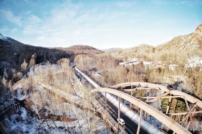 Aerial view of bridge over land against sky during winter