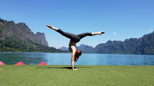 Handstand on floating barge in khao sok national park