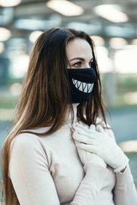 Woman wearing mask looking away