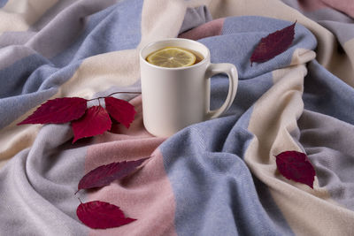 Close-up of coffee cup on bed