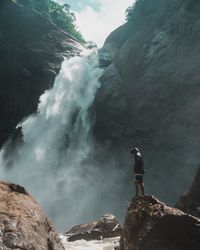 Rear view of man standing on mountain