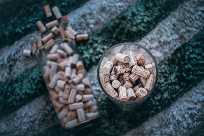 High angle view of wine corks in drinking glasses on table