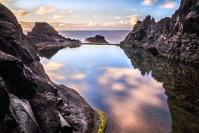 Close-up of rock formation in sea against sky