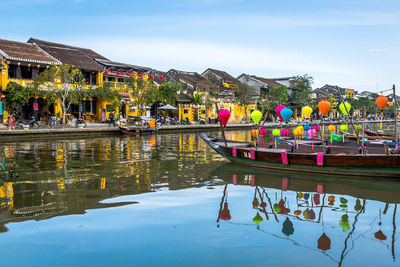 Group of people in lake against buildings