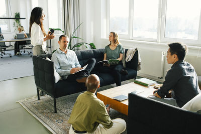 Business professionals discussing with each other at office