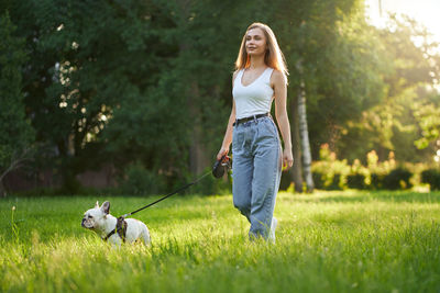 Woman with dog on grass