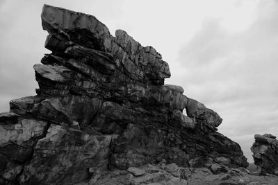 Low angle view of rock formation against sky