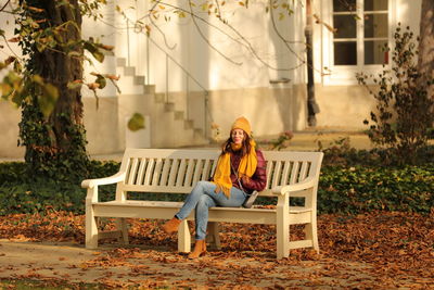 Woman sitting on bench in park