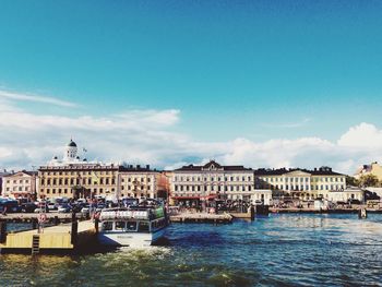 River by city against blue sky