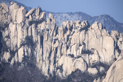 Low angle view of snow on rocky mountain at seoraksan national park