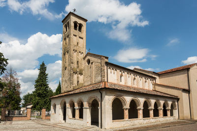 Low angle view of church against cloudy sky