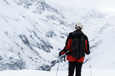 Tourists walking on snow covered landscape