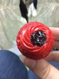 Close-up of hand holding red fruit