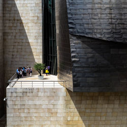 People on wall of building