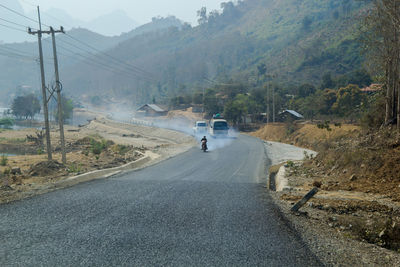 Man riding motorcycle on road