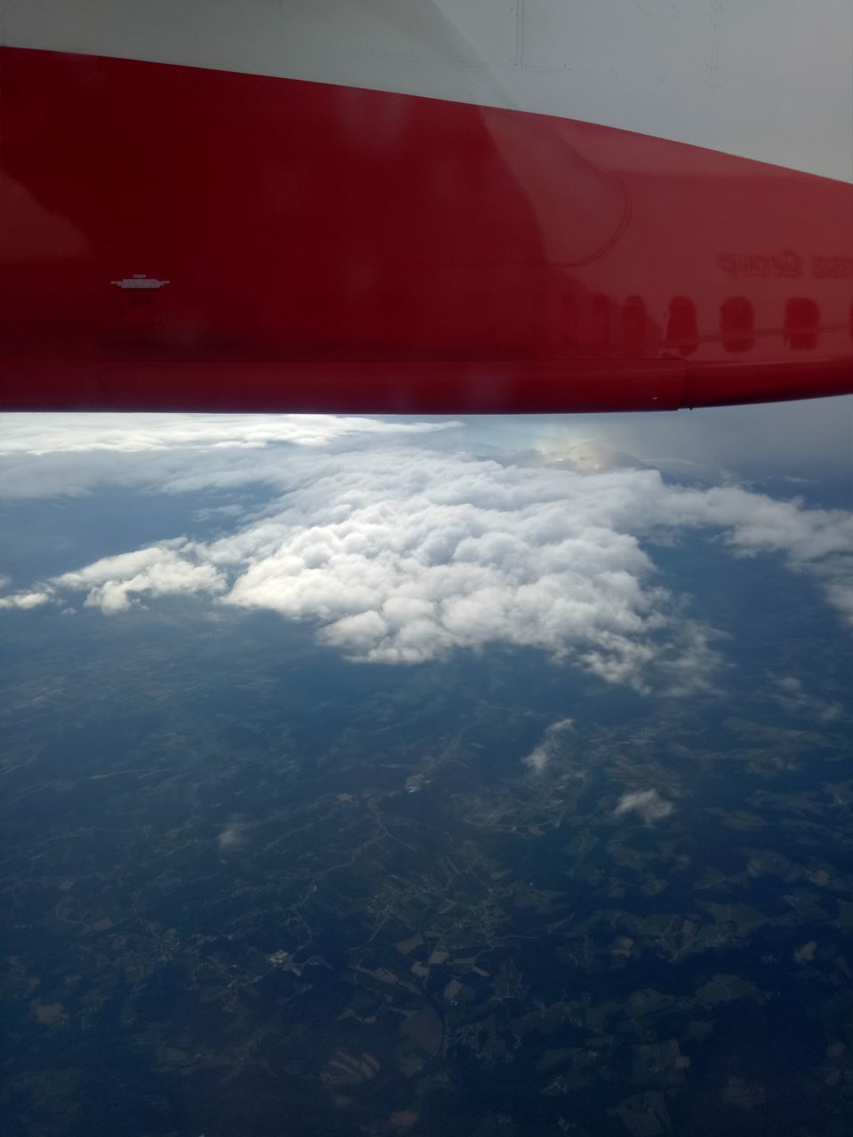 AERIAL VIEW OF RED AIRPLANE WING