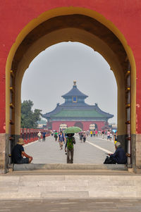 People in temple against sky on sunny day