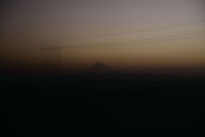 Scenic view of silhouette mountain against sky at sunset