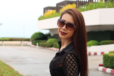 Portrait of smiling woman standing outdoors