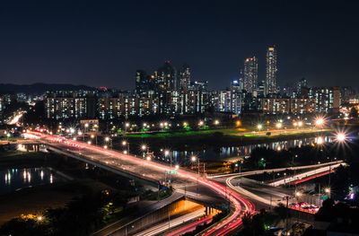 Light trails on road in city at night