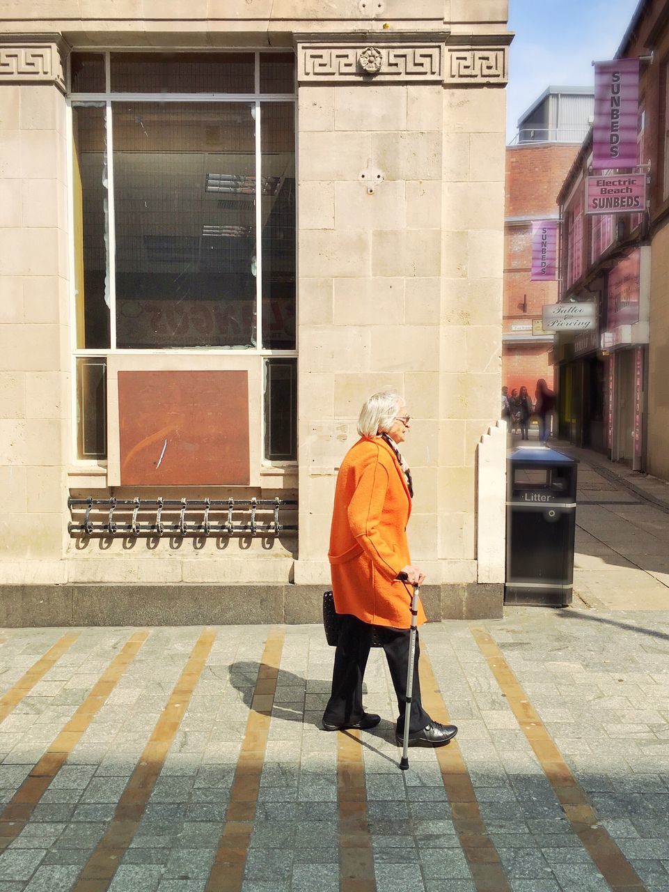 building exterior, full length, architecture, street, rear view, lifestyles, built structure, casual clothing, walking, city, men, leisure activity, city life, standing, sidewalk, person, outdoors, day