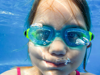 Close-up portrait of girl swimming in pool