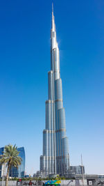 Low angle view of modern building against clear blue sky