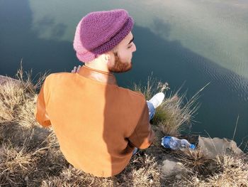 A indian muslim boy sitting top of the lake and looking some beautiful nature 