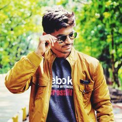 Portrait of young man wearing sunglasses standing outdoors