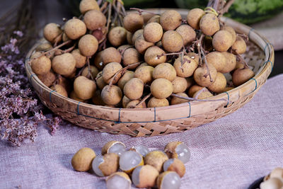 Close-up bunch of ripe longan fruit on bamboo basket