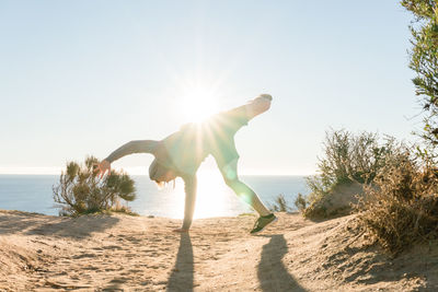 Man on beach against clear sky