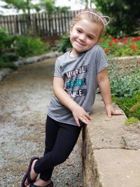 Portrait of smiling girl standing outdoors