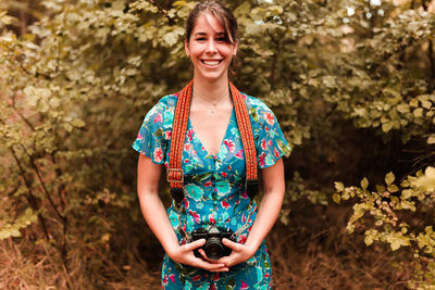 Portrait of a smiling young woman standing outdoors