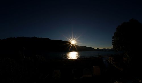 Scenic view of lake against bright sun