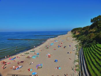 Scenic view of beach against clear blue sky