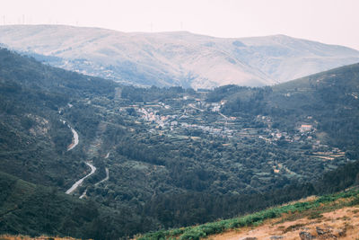 High angle view of valley and mountains against sky