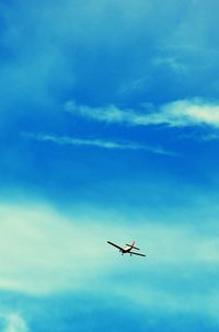 Low angle view of airplane flying in sky