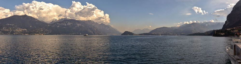 Scenic view of sea and mountains against sky