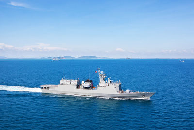 Warship sailing in sea against sky