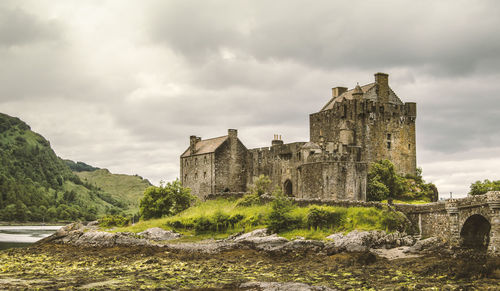 Castle by city against sky