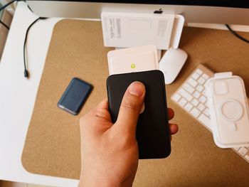 Close-up of person using laptop on table