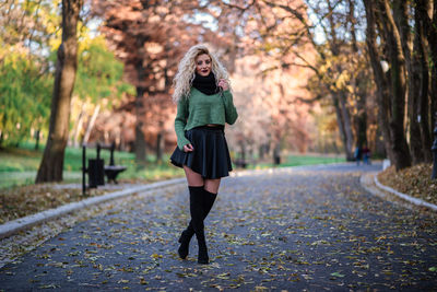 Full length of woman in park during autumn