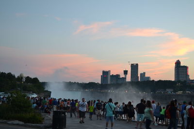 Crowd at city during sunset