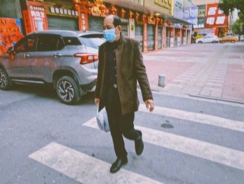 Man walking on street in city